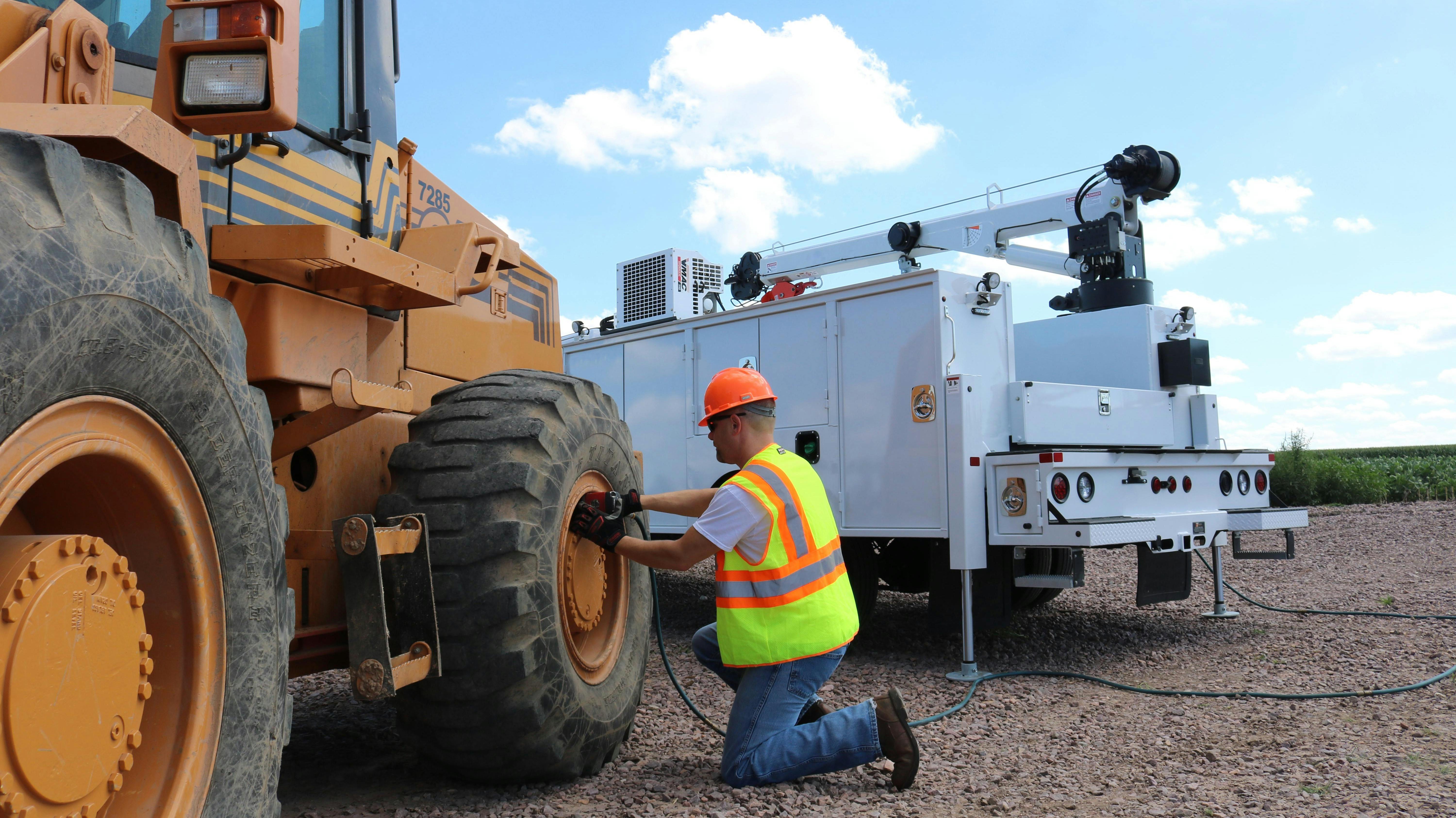 VMAC hydraulic air compressor on a crane truck working on a wheel loader