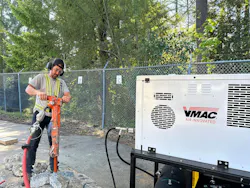 Man using jackhammer with a VMAC compressor.