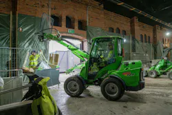 Avant Tecno USA e727 small articulated loader reading above a worker.