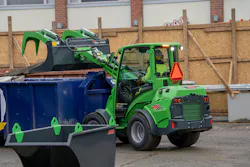 Avant Tecno USA e727 small articulated loader dumping into a bin.