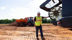 A man checks the fan on a Develon articulated dump truck.