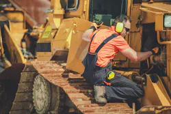 A mechanic works on a dozer.
