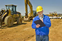 Construction mechanic checks off machines from his clipboard.