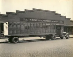 An early Omaha Standard stock body stretches behind a truck parked outside an International Harvester dealership.