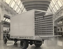 An early Omaha Standard truck body features a large open rear and fold-down tailgate for loading and unloading cargo.