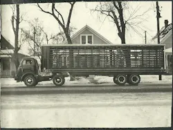 An Omaha Standard livestock body stretches across a tandem-axle truck in this archival winter photo. The long slatted body reflects the company’s deep roots in livestock hauling equipment.