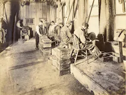 Omaha Standard workers grind and finish metal components inside the company’s factory.