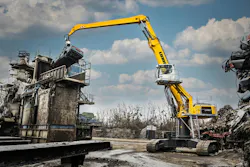 Liebherr LH 60 C Material Handler High Rise version lifting a car in a scrap year.