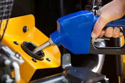 A mechanic fills DEF in a Volvo Construction Equipment machine.