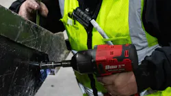 Technician tightening bolt on bucket