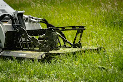 Ignite Attachments 44-inch Mini Brush Cutter on a Bobcat mini skid steer, sitting in a pasture.