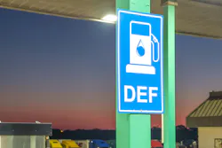 Diesel exhaust fluid or DEF sign posted in a truck stop, next to fuel pump.