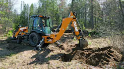 Case 580 Super N backhoe loader digging in a forest.
