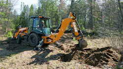 Case 580 Super N backhoe loader digging in a forest.