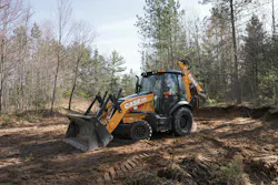 A Case Construction Equipment 580 Super N backhoe loader driving through a forest.
