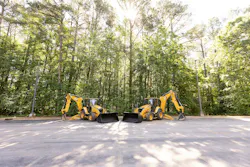 Cat 440 and 450 backhoe loaders parked next to each other.
