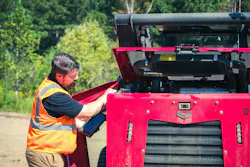 A mechanic inspects a Yanmar compact track loader.