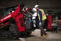 A dealer inspects the engine bay of a Yanmar compact track loader.