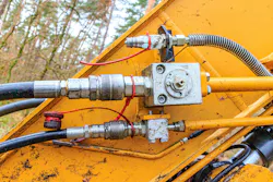 Hydraulic connections on the boom of an excavator.
