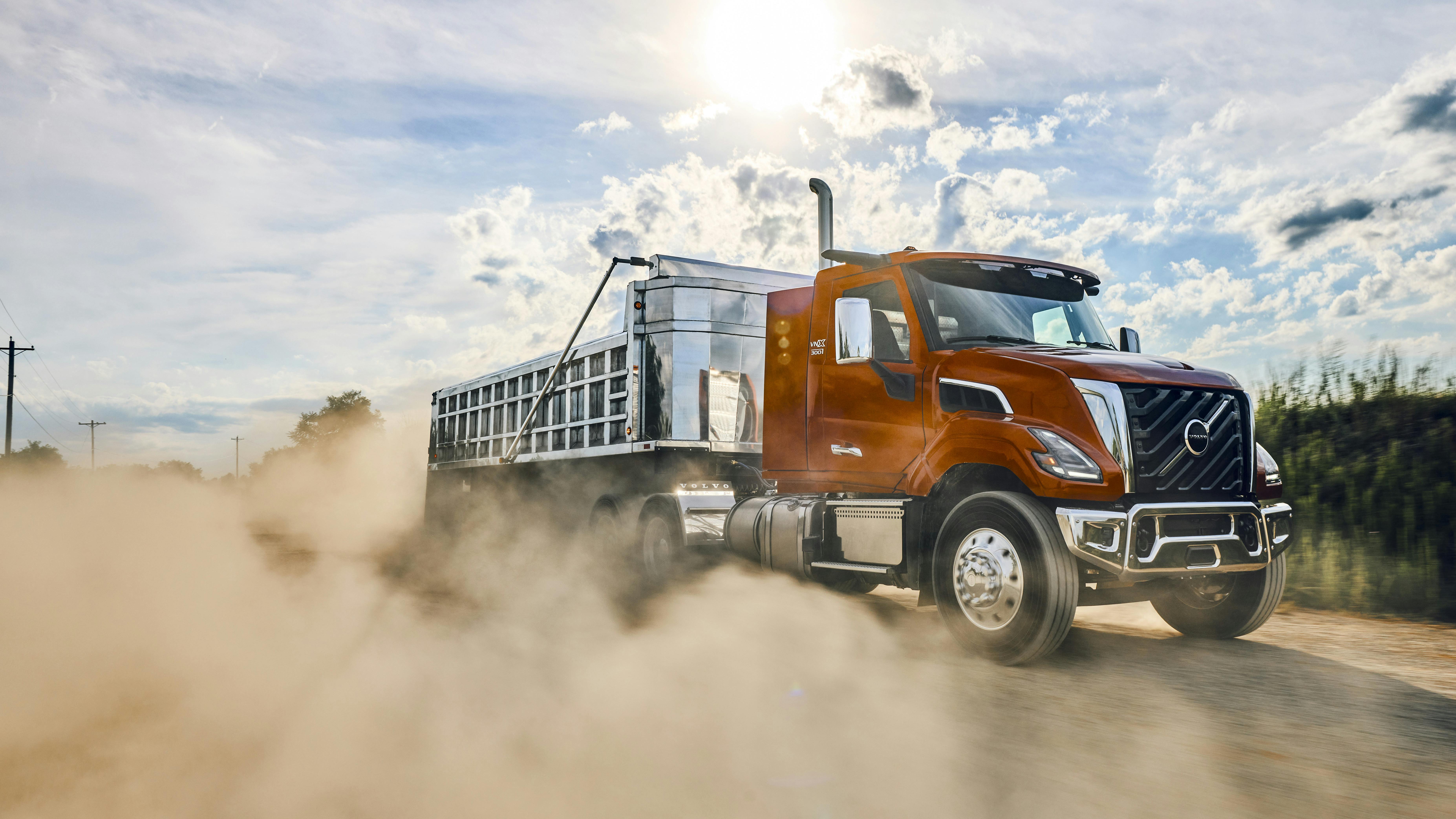 Volvo's VNX 300 vocational truck with an aggregate trailer, kicking up dirt.