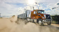 Volvo's VNX 300 vocational truck with an aggregate trailer, kicking up dirt.