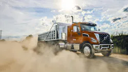 Volvo's VNX 300 vocational truck with an aggregate trailer, kicking up dirt.