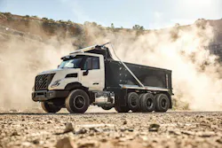 Volvo's VNX 300 dump truck, background but dirt in the air.