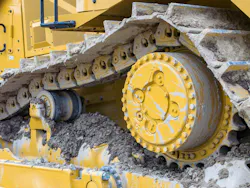 A Caterpillar D8 dozer undercarriage filled with dirt.