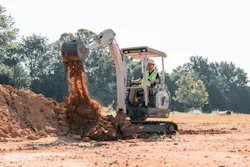 A Takeuchi TB20e Electric Excavator works in the dirt.
